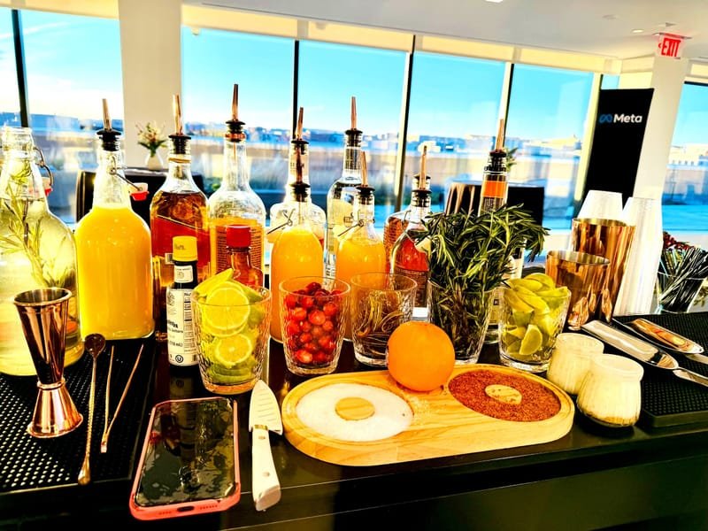 Bar mixers, fresh fruit, herbs and spirits laid out ready for service
